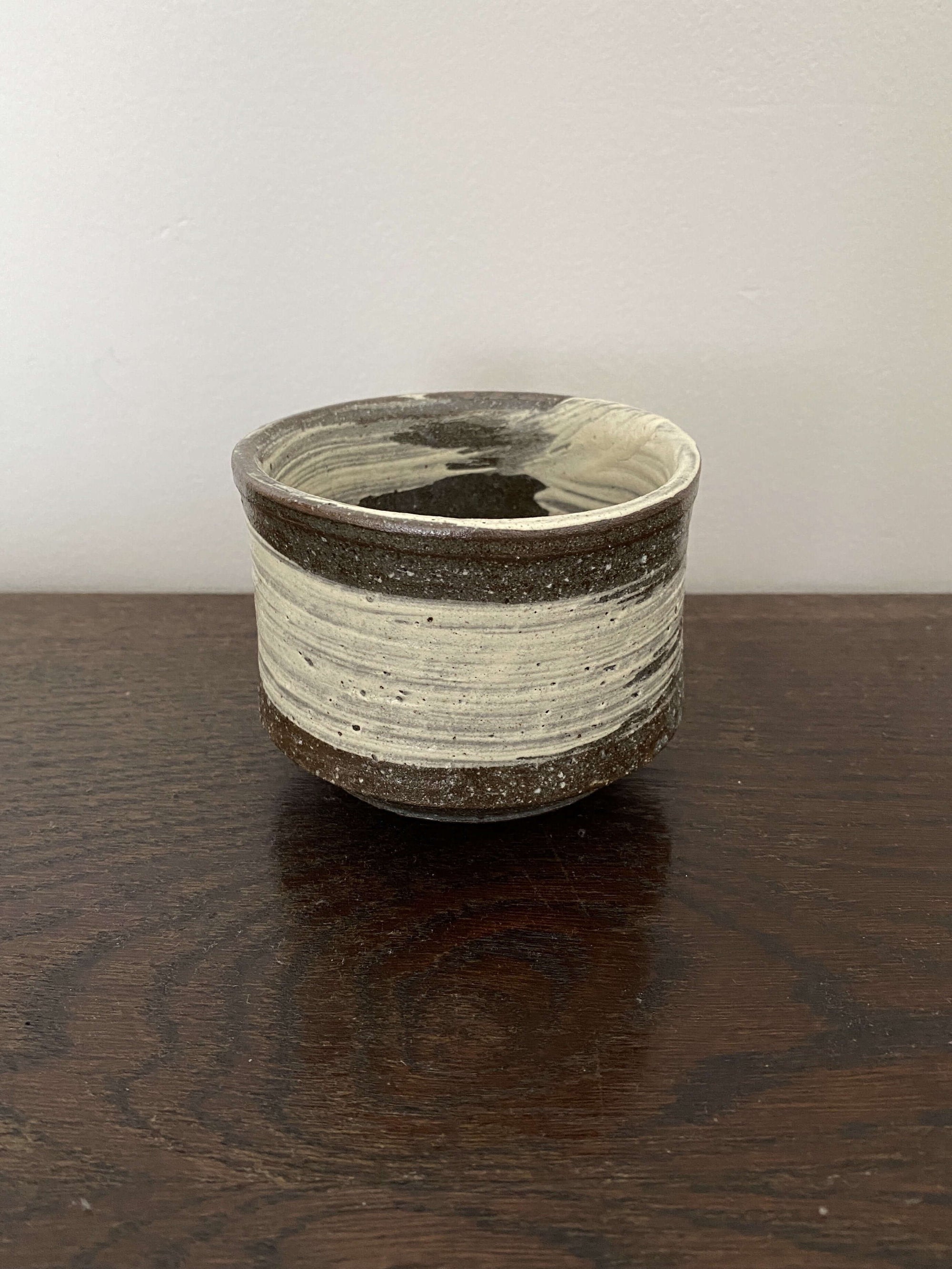 Ceramic Wabi-Sabi Matcha Bowl on wooden surface, Japanese design perfect for traditional matcha tea preparation.