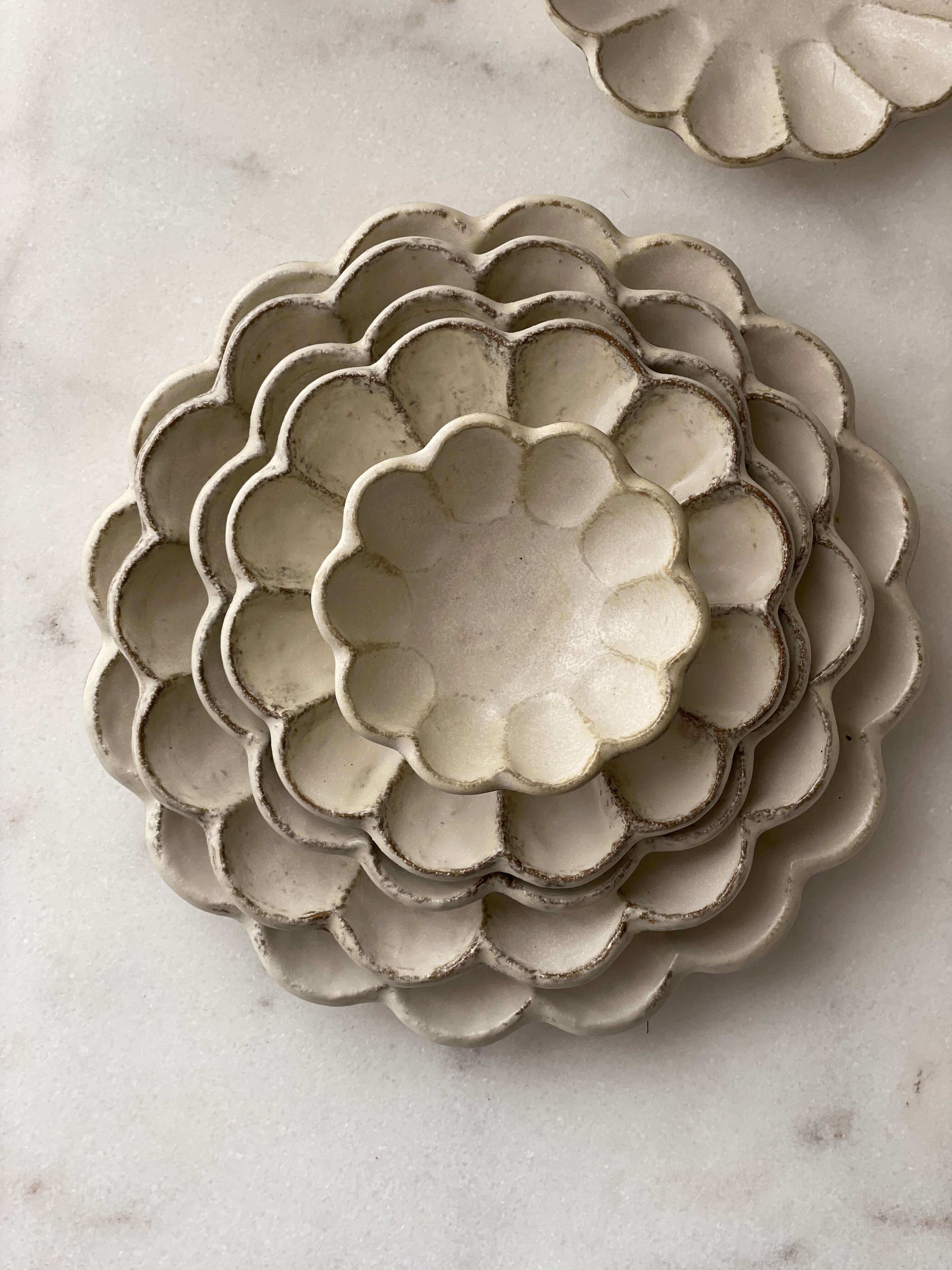 Handcrafted Rinka porcelain plates with flower petal design, showcasing Japanese craftsmanship by Kaneko Kohyo.