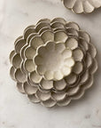 Handcrafted Rinka porcelain plates with flower petal design, showcasing Japanese craftsmanship by Kaneko Kohyo.