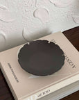 Elegant Yukiwa Plate by Yoshida Pottery on a table, showcasing its nature-inspired design and sophisticated charm.