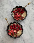 Rinka Bowls by Kaneko Kohyo filled with fresh raspberries, nuts, and yogurt on a marble surface.