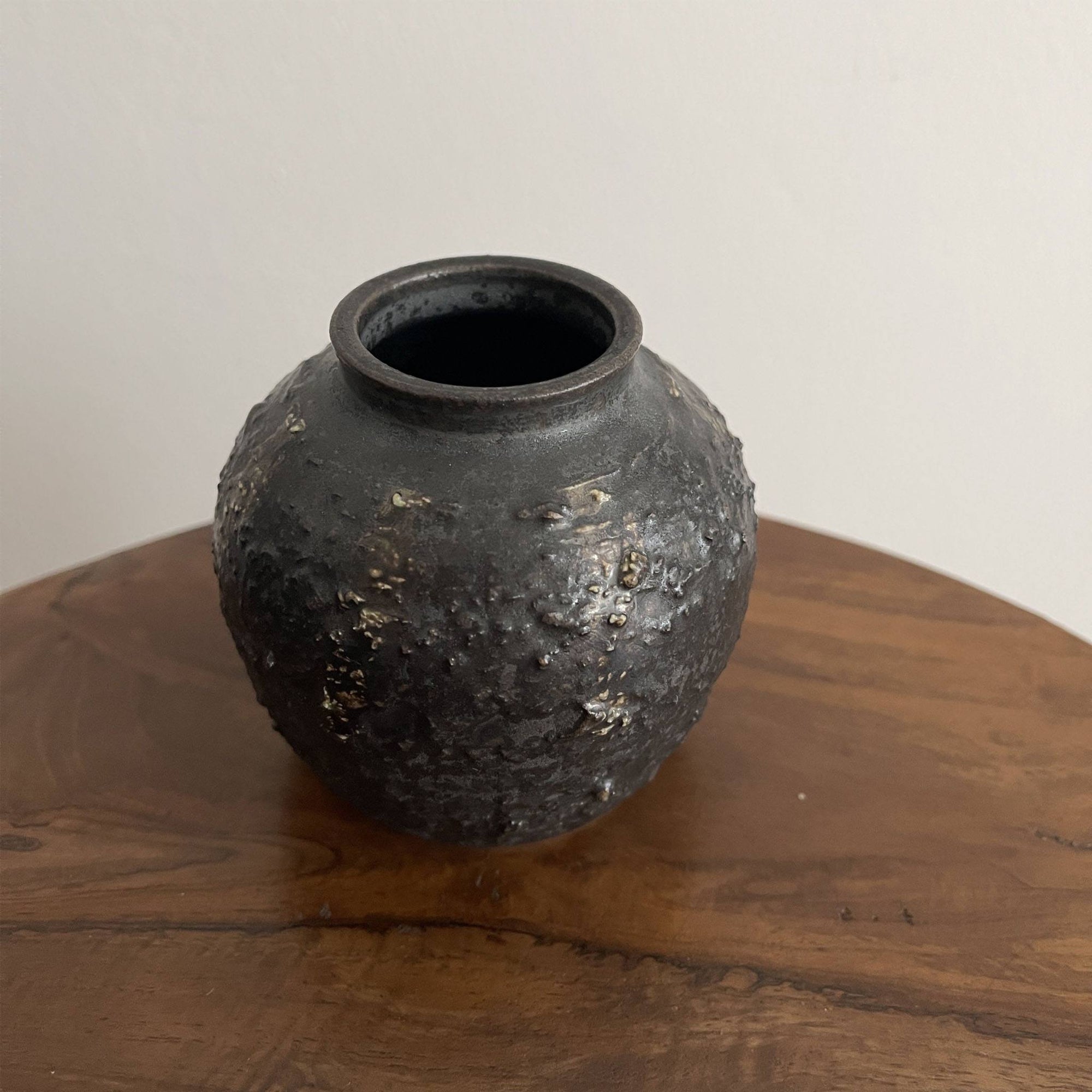 Shabby Chic Black Vase from Yoshida Pottery Collection with nature-inspired patterns on a wooden table. Elegant home decor piece.