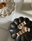 Elegant handcrafted Rinka plates from the Japanese collection, showcasing unique scalloped design and artistry in black and white.