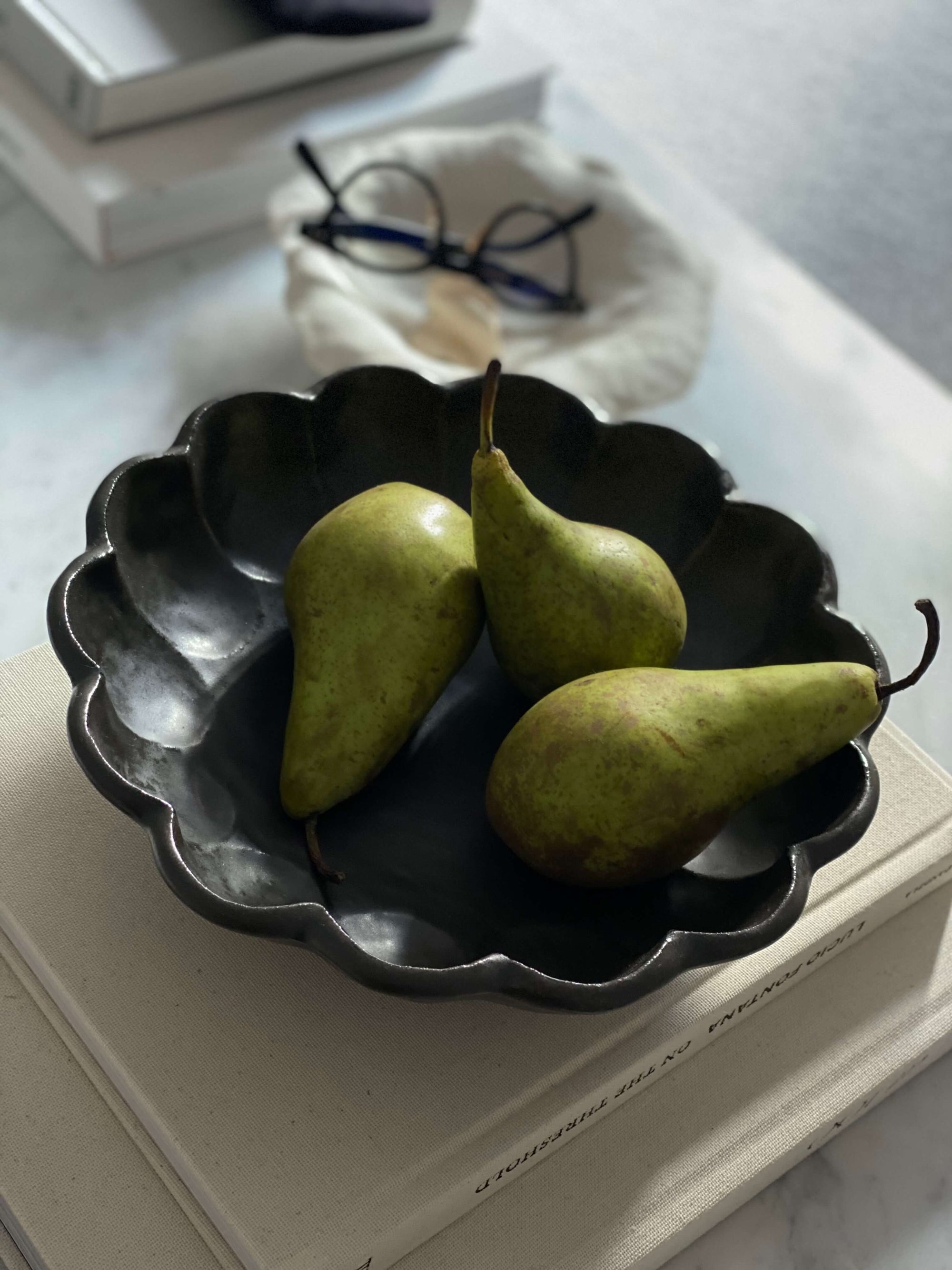 Porcelain Rinka Bowl 21cm with pears, showcasing its flower shape and elegance in a tabletop setting.