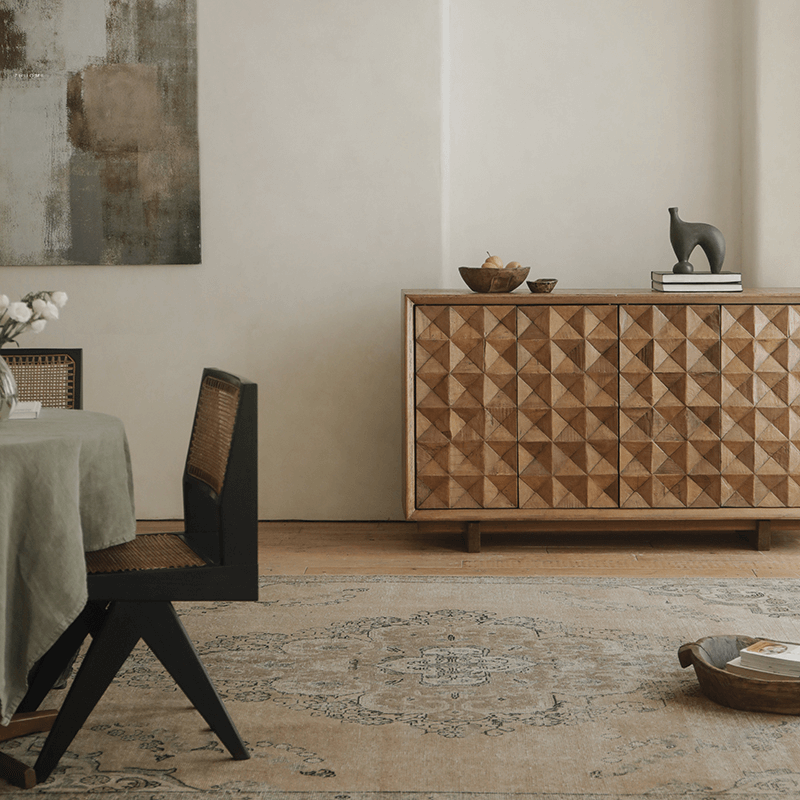 Medieval sideboard cabinet with intricate design in a rustic dining room setting, featuring a decorative sculpture on top.