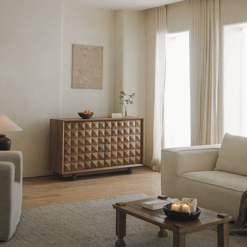 Elegant living room featuring a medieval sideboard cabinet with geometric design, accentuating a blend of modern and vintage decor.