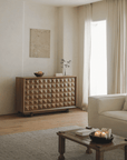 Elegant living room featuring a medieval sideboard cabinet with geometric design, accentuating a blend of modern and vintage decor.