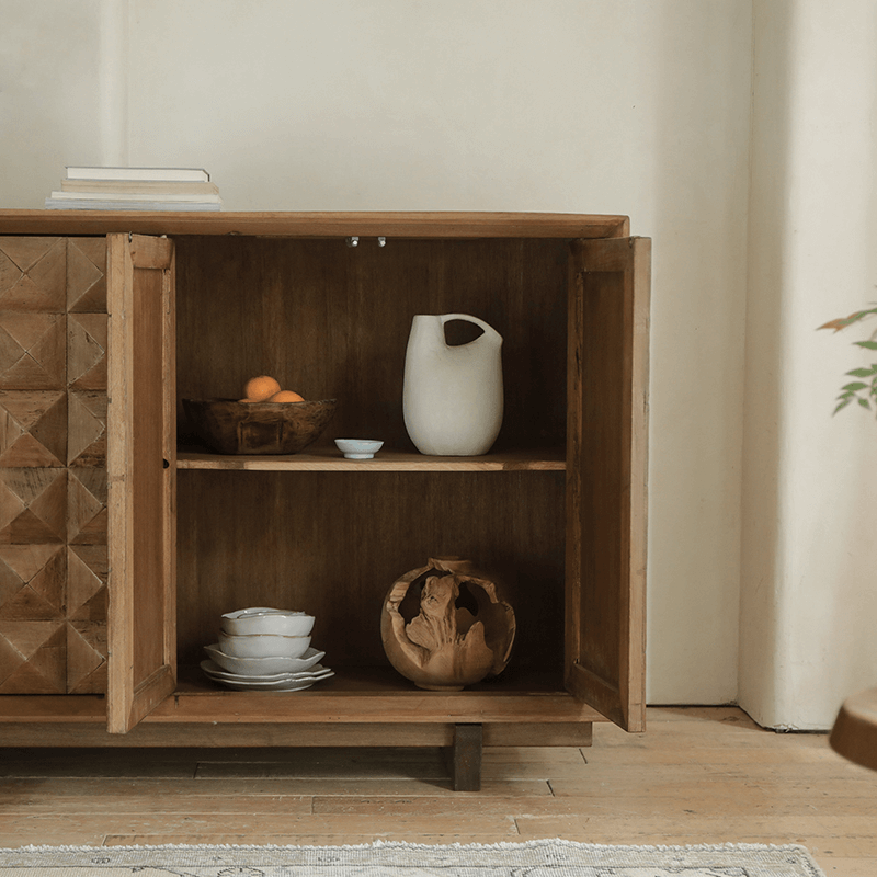 Medieval sideboard cabinet with open wooden doors revealing shelves, featuring rustic pottery and books for a vintage touch.
