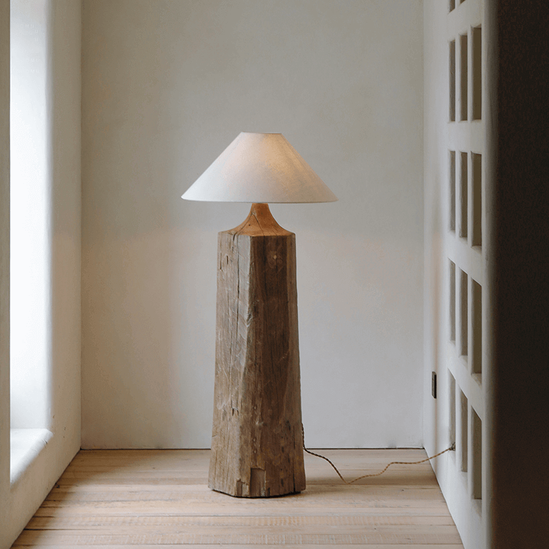 Rustic Stake Floor Lamp with linen shade and dimmable old wood base for cozy, mood-enhancing lighting in modern interiors.
