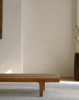 Natural elm fence coffee table in minimalist room setting with rustic decor.