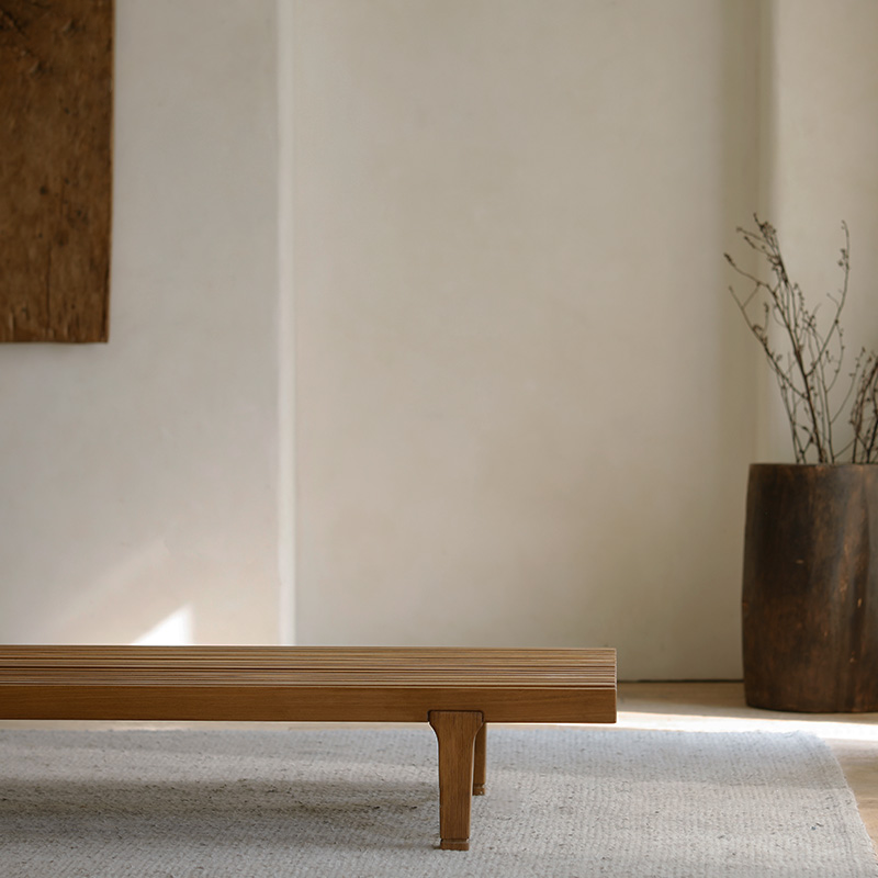 Natural elm fence coffee table in minimalist room setting with rustic decor.