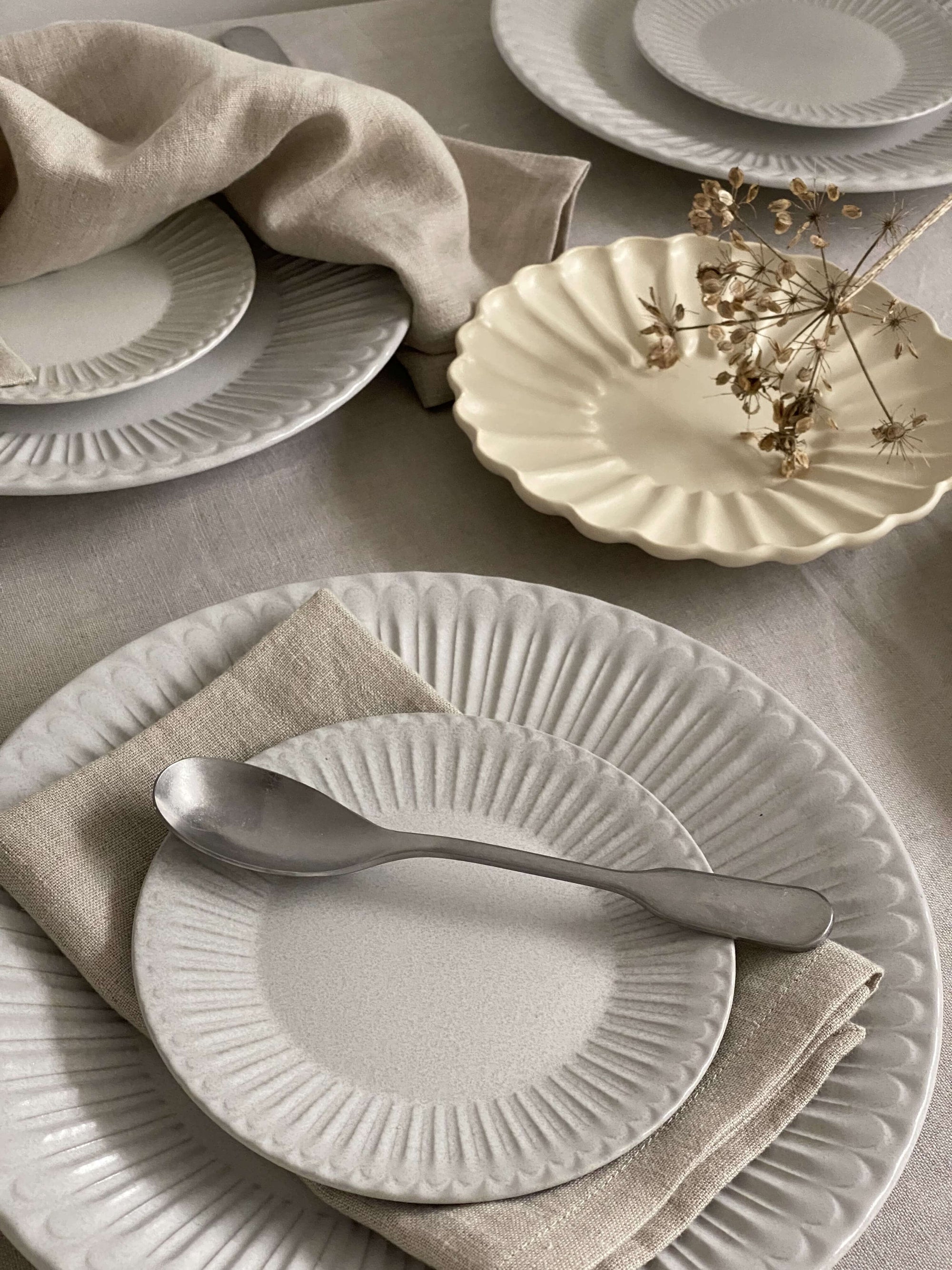Elegant porcelain plates with a lace edge design, featuring a nostalgic and romantic setting, perfect for dining sophistication.