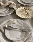 Elegant porcelain plates with a lace edge design, featuring a nostalgic and romantic setting, perfect for dining sophistication.