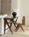 Hand-made wood-mounted dining chair with rattan weaving, set against a modern desk and sofa, enhancing a room's romantic vibe.