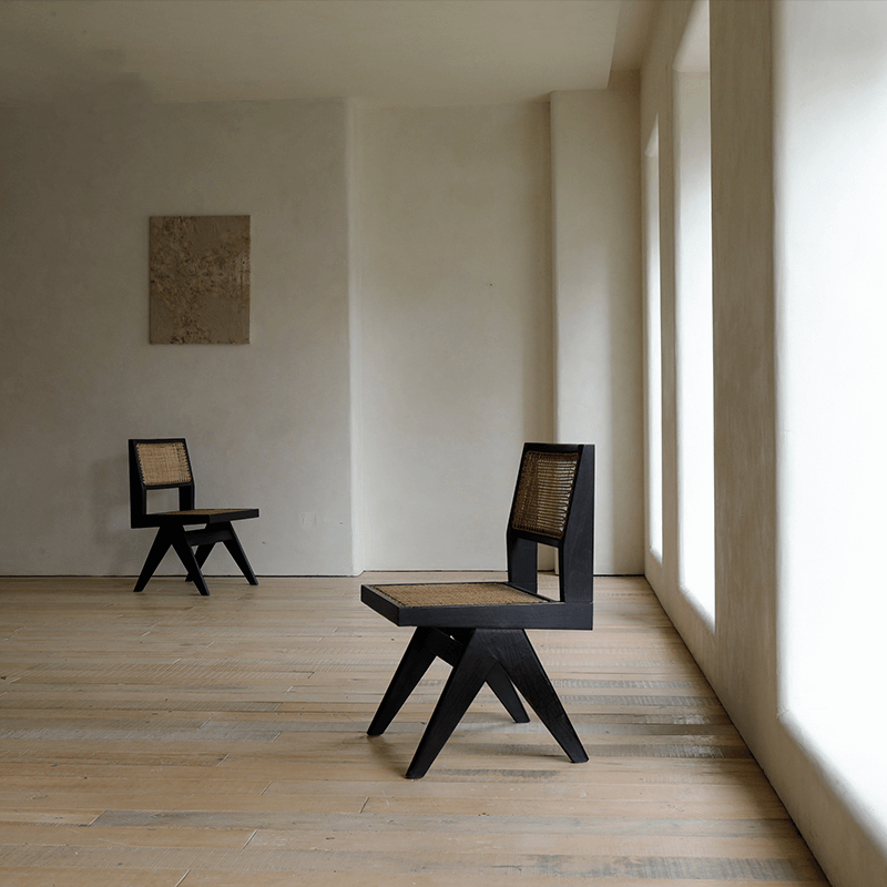 Elegant hand-made rattan wood-mounted dining chairs with teak wood and natural weaving in a minimalist room setting.