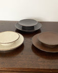 Collection of Rila Ivory 11.5cm porcelain plates by Kaneko Kohyo, featuring a textured, warm finish; perfect with Rila Mugs.
