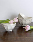 Elegant Rinka Small Soup Bowls 10.5cm, handmade in Japan, paired with tulips, showcasing unique glaze texture and craftsmanship.