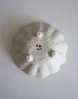 Bottom view of Rinka Bowl 12cm in porcelain, showcasing Japanese craftsmanship and flower-shaped base from Kaneko Kohyo's collection.