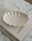 Porcelain Rinka Oval Bowl 28cm with flower shape on book, part of Kaneko Kohyo's handcrafted collection, Japan's delicate tableware.