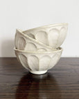 Three stacked Rinka Large Soup Bowls in delicate porcelain with flower shape, part of Kaneko Kohyo's Rinka Collection from Japan.