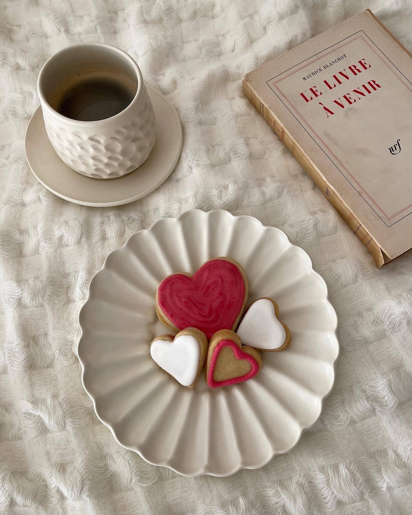 Elegant Rinka Plate by Yoshida Pottery with heart-shaped cookies, coffee, and book on a cozy table setting.