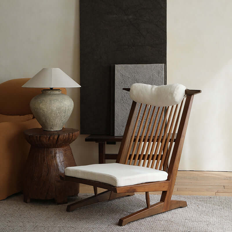 Nakajima George Reclining Chair in teak wood with rattan weaving, natural linen cushion, and romantic design in a cozy room setting.