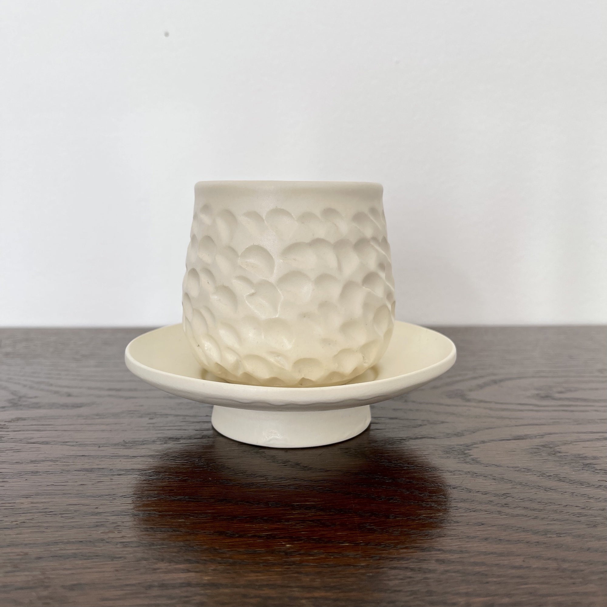 Elegant Shinogi Cup and Saucer Set by Masakazu Yoshida with nature-inspired design on dark wood table from Yoshida Pottery Collection.