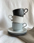 Storia Coffee Cup & Saucer with soft lace edges and flecked finish, inspired by antique European design, stack of three cups.