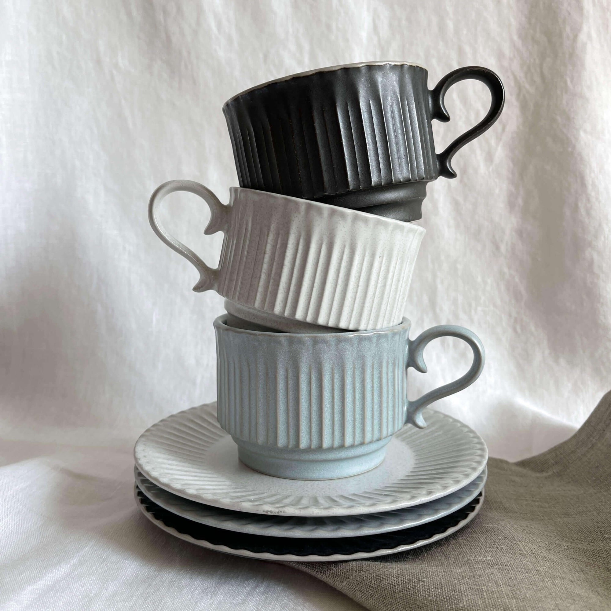 Storia Coffee Cup & Saucer set in black, white, and grey, inspired by antique European tableware, with porcelain lace design.