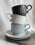 Storia Coffee Cup & Saucer set in black, white, and grey, inspired by antique European tableware, with porcelain lace design.