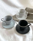 Elegant Storia Tall Coffee Cup & Saucer set in three colors, featuring a high-quality earthenware texture and antique-style design.