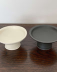Elegant black and white tall plates from Yoshida Pottery, adding a touch of nature-inspired sophistication to any table setting.
