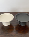 Elegant black and white tall plates from Yoshida Pottery, adding a touch of nature-inspired sophistication to any table setting.