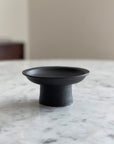 Tall Plate by Yoshida Pottery on marble table, designed with nature-inspired patterns for elegant table settings.