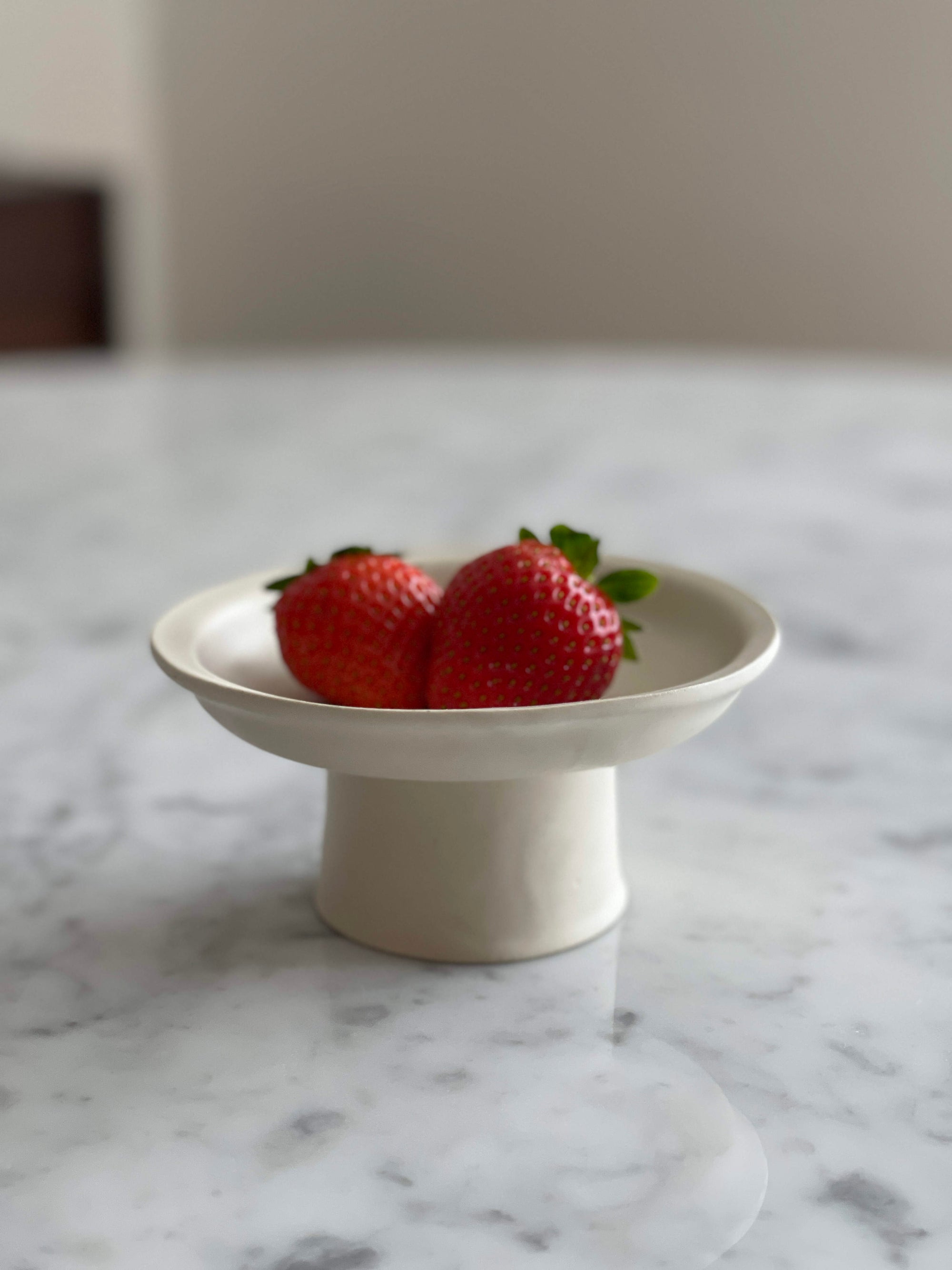 Elegant Tall Plate by Yoshida Pottery with strawberries on a marble table, showcasing nature-inspired patterns and fine craftsmanship.