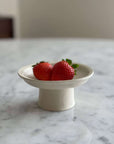 Elegant Tall Plate by Yoshida Pottery with strawberries on a marble table, showcasing nature-inspired patterns and fine craftsmanship.