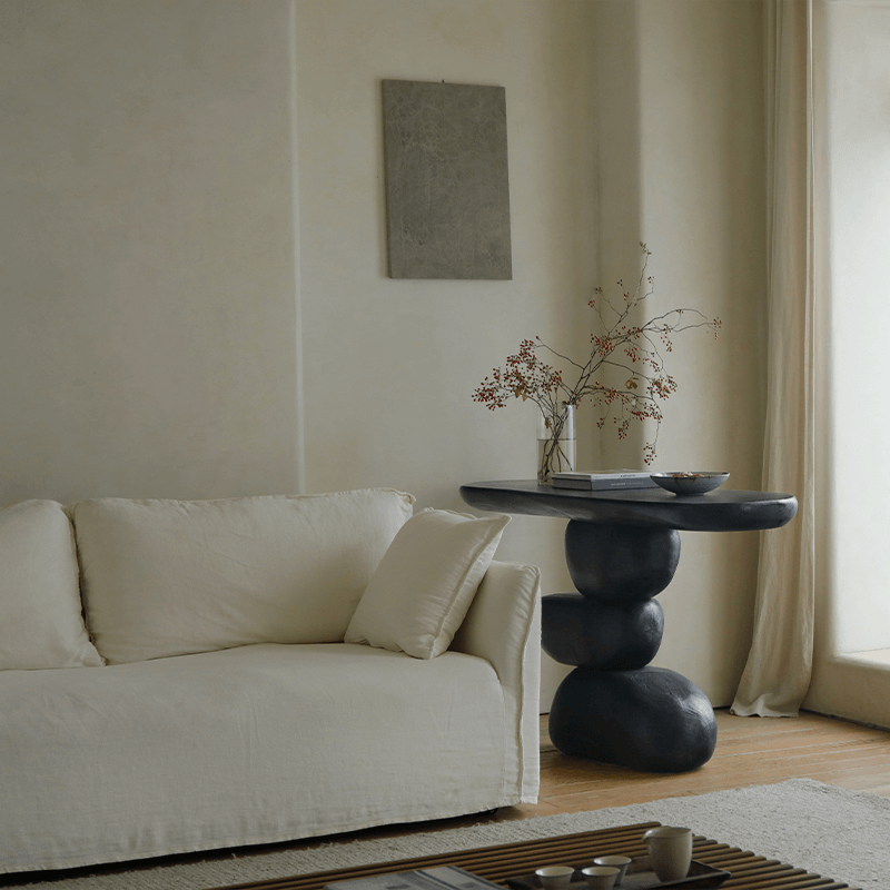 Minimalist living room with a Wabi-Sabi porch table made of natural wood, featuring a unique design with retro nostalgic elements.