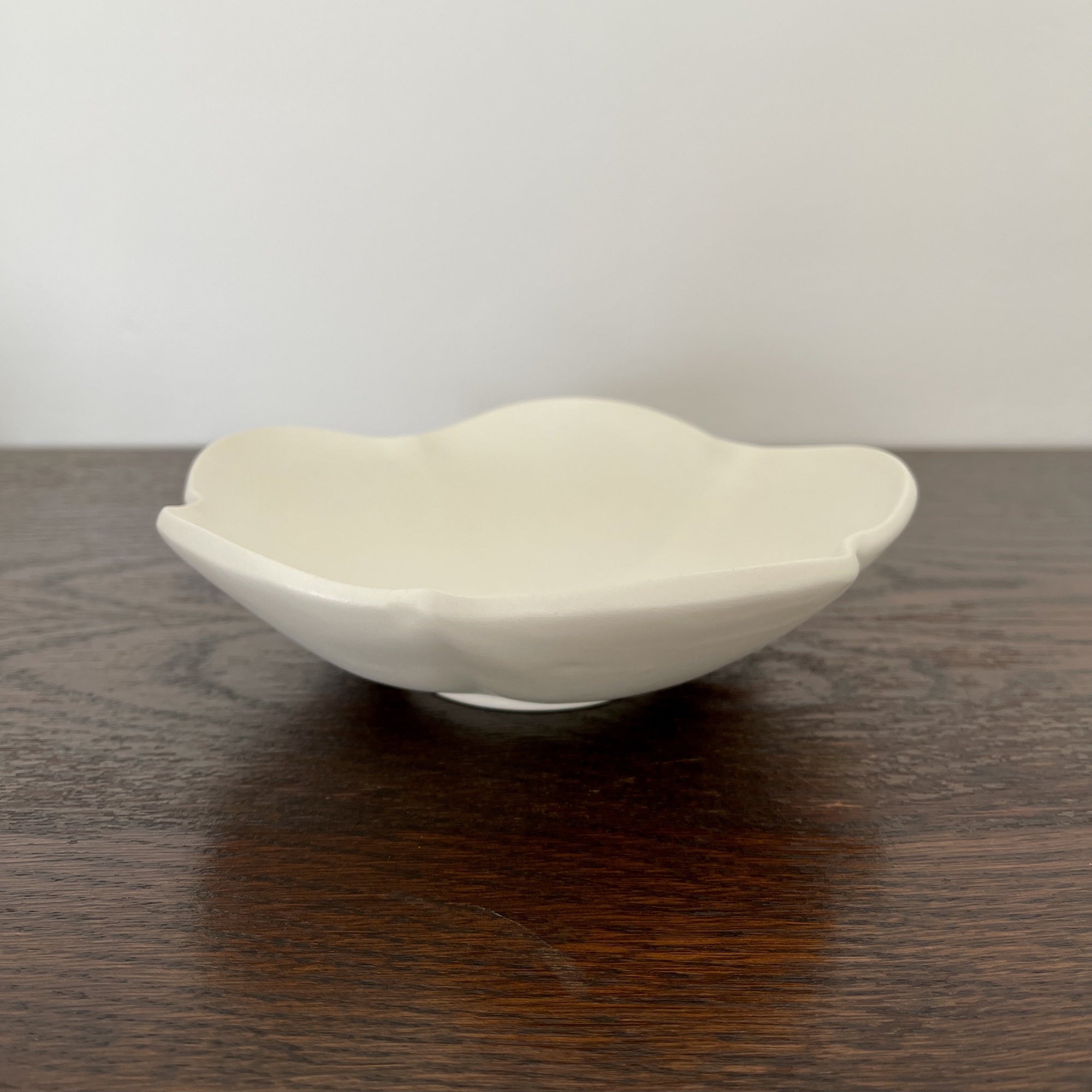 Elegant UME bowl from Yoshida Pottery Collection by Masakazu Yoshida, showcasing nature-inspired design on a wooden table.