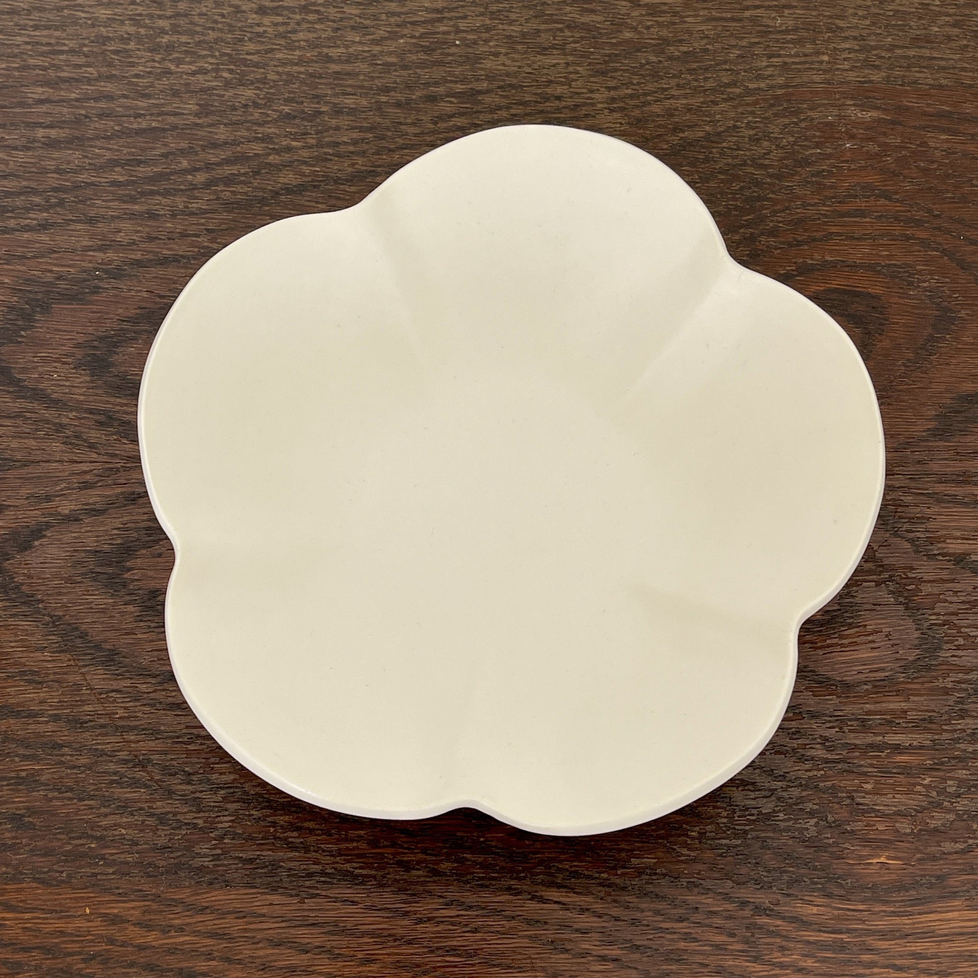 Elegant UME bowl from Yoshida Pottery, featuring nature-inspired patterns, crafted by ceramist Masakazu Yoshida, on a wooden table.