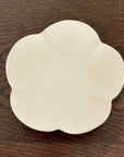 Elegant UME bowl from Yoshida Pottery, featuring nature-inspired patterns, crafted by ceramist Masakazu Yoshida, on a wooden table.