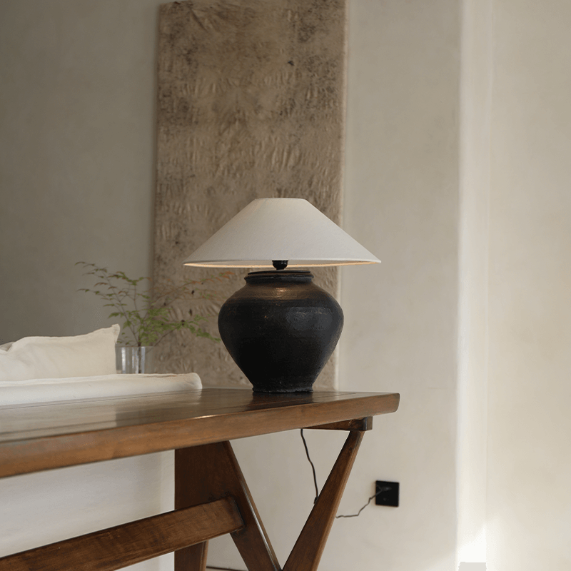 Wabi-Sabi style handmade table lamp with milky white and black body, linen lampshade, creating a peaceful and artistic atmosphere