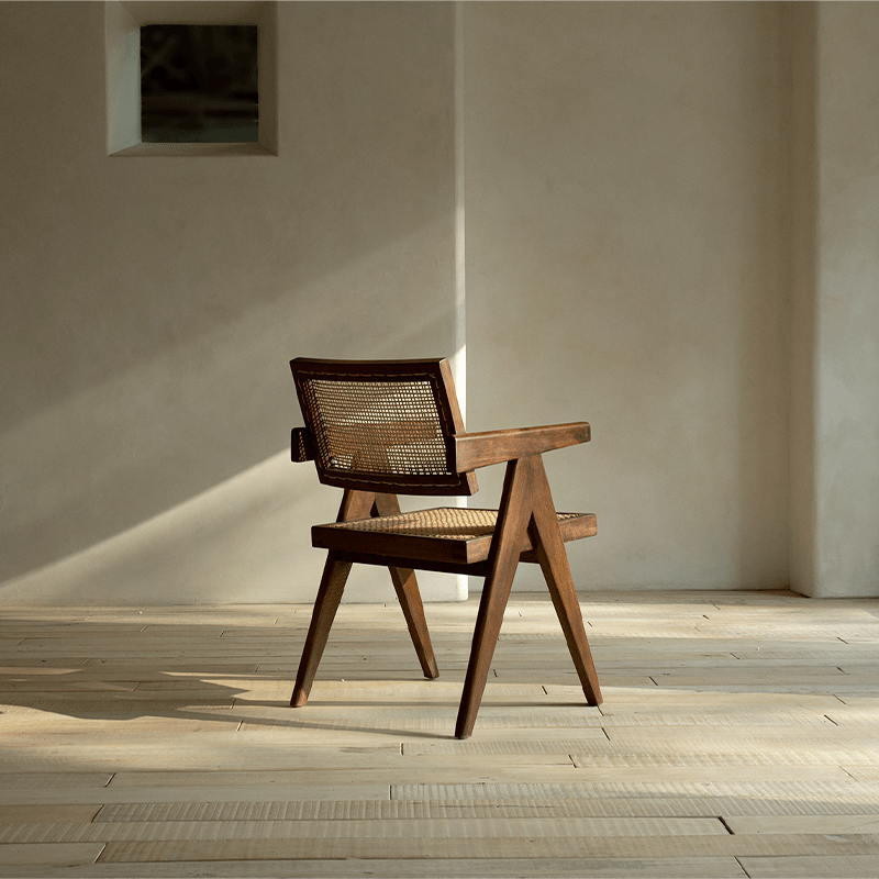 Chandigarh chair in teak and rattan with wabi-sabi design, showcasing minimalism and intricate carvings, perfect for peaceful living spaces.