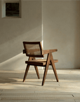 Chandigarh chair in teak and rattan with wabi-sabi design, showcasing minimalism and intricate carvings, perfect for peaceful living spaces.