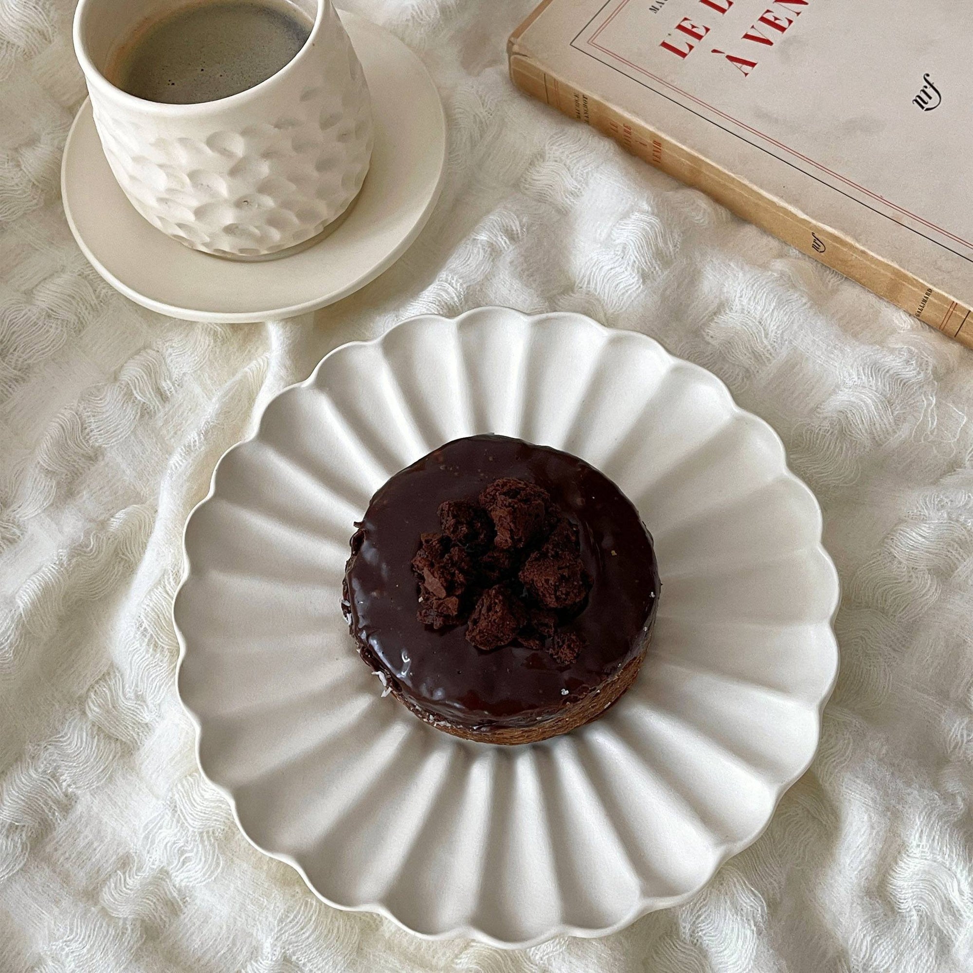 "Rinka Plate by Yoshida Pottery with chocolate dessert and coffee, showcasing an elegant table setting"