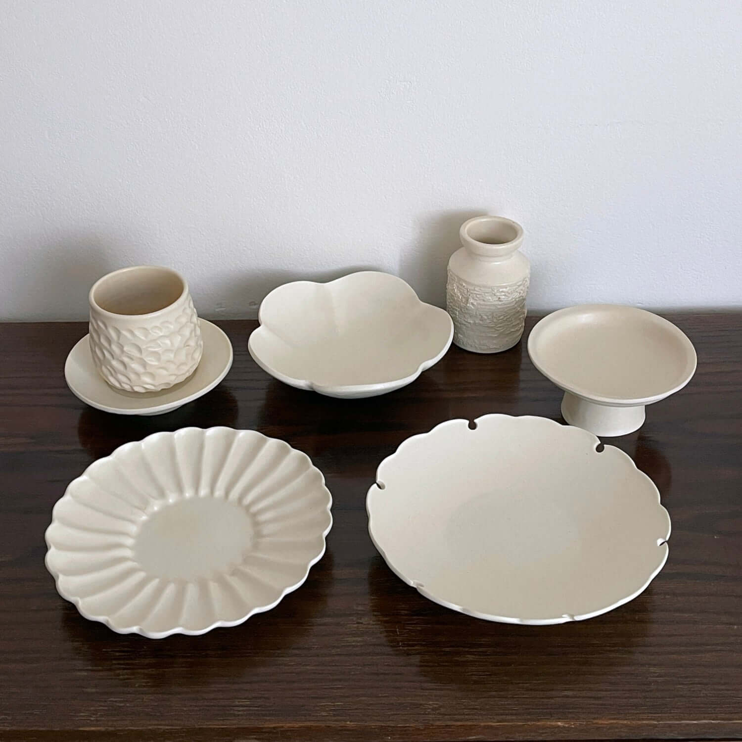 Yoshida Bundle featuring Rinka Plate, Ume Bowl, Shinogi Cup & Saucer, Yukiwa Plate, and White Vase displayed on a wooden surface.