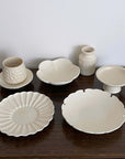 Yoshida Bundle featuring Rinka Plate, Ume Bowl, Shinogi Cup & Saucer, Yukiwa Plate, and White Vase displayed on a wooden surface.