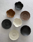 Assorted Rinka Plates by Yoshida Pottery displayed on a white surface, showcasing nature-inspired patterns and elegant designs.