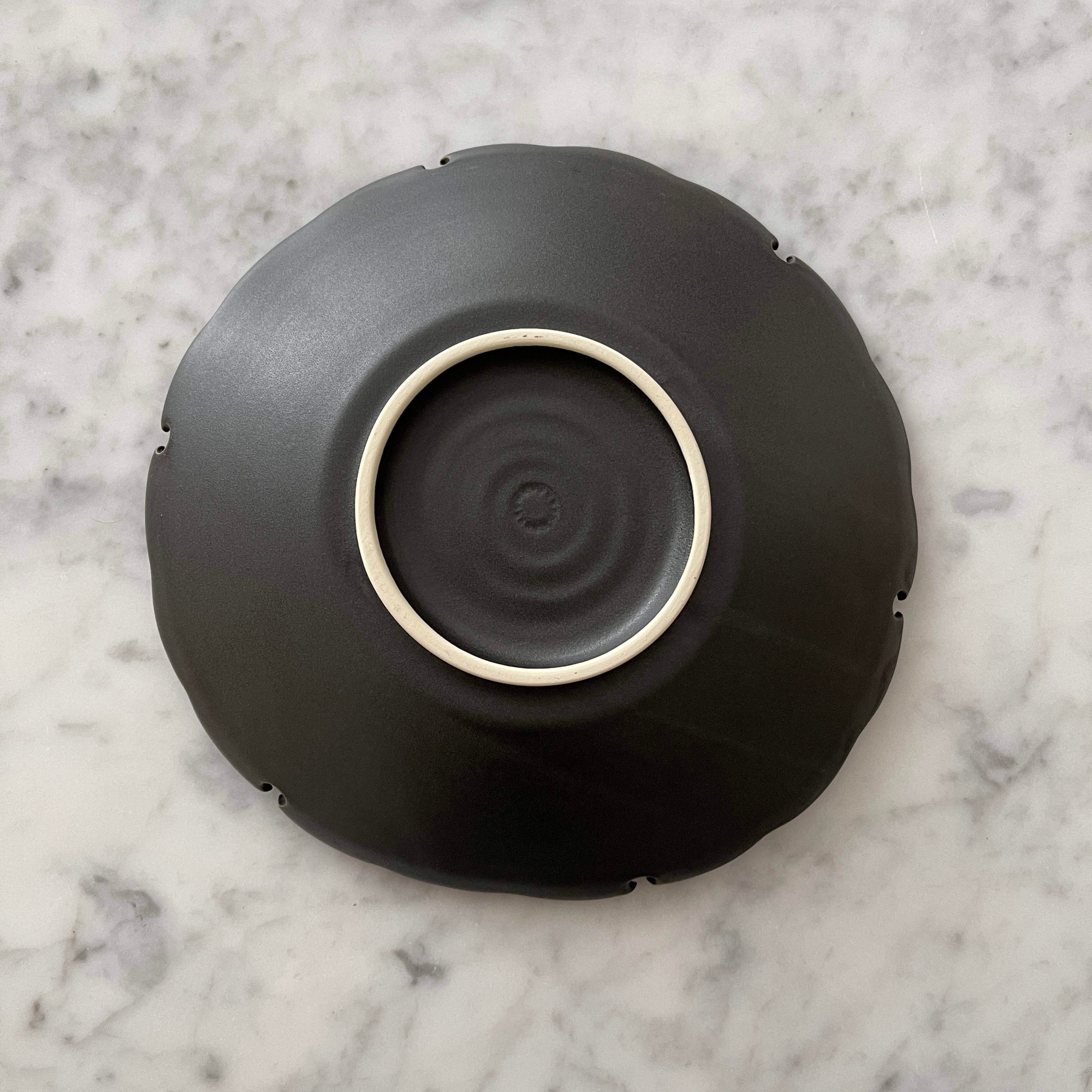 Yukiwa Plate by Yoshida Pottery showcasing nature-inspired design on a sleek surface, perfect for elegant table settings.
