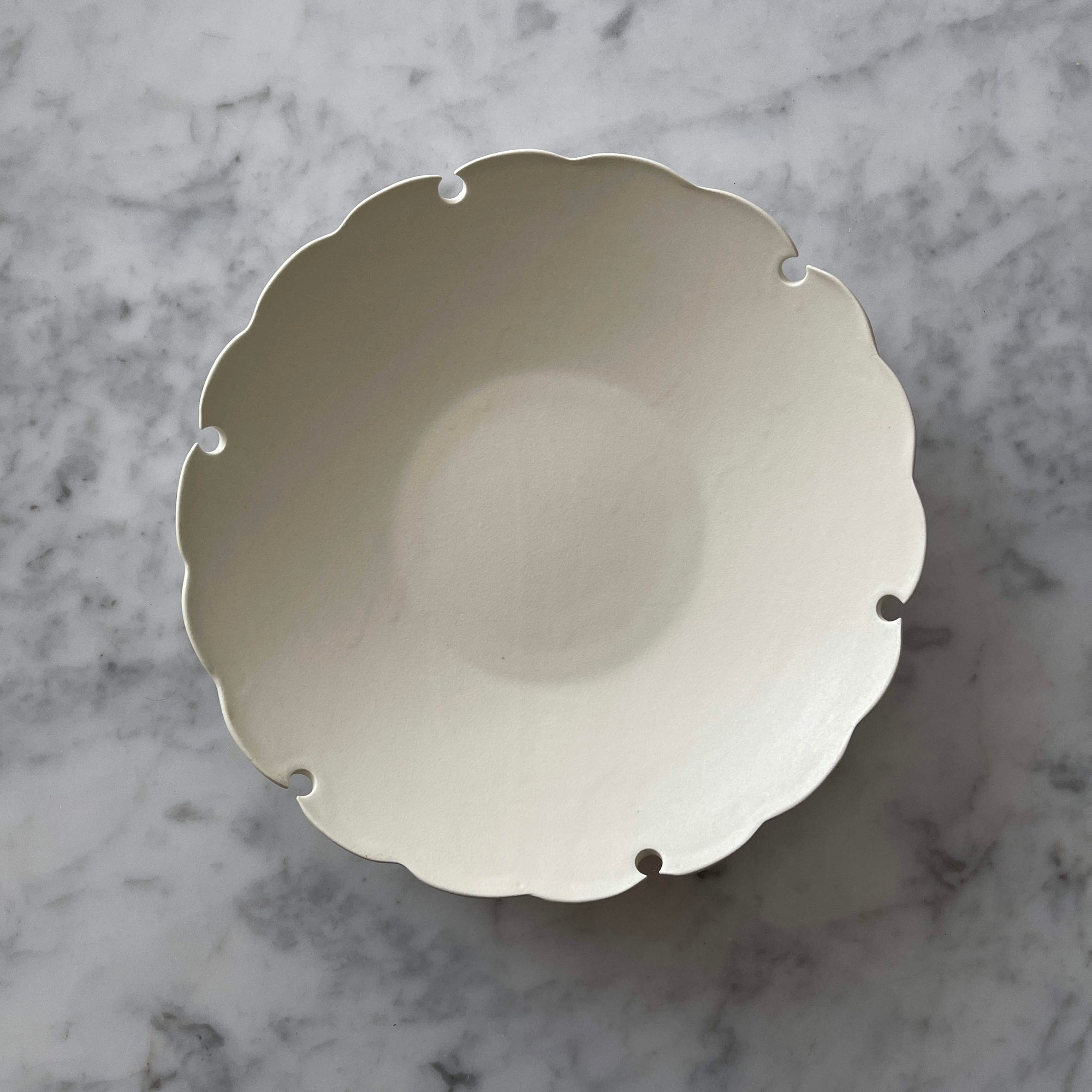 Yukiwa Plate by Yoshida Pottery with nature-inspired design on a marble surface. Elegant ceramic dishware by Masakazu Yoshida.