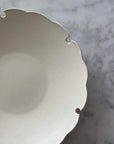 Elegant Yukiwa Plate by Yoshida Pottery with nature-inspired design, showcasing unique scalloped edges on a marble background.